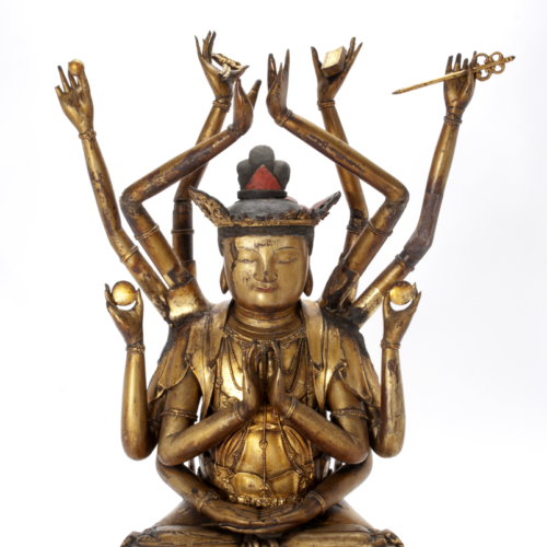 A carbved wooden figure of Guanyin the God(dess) of Mercy covered in gold lacquer