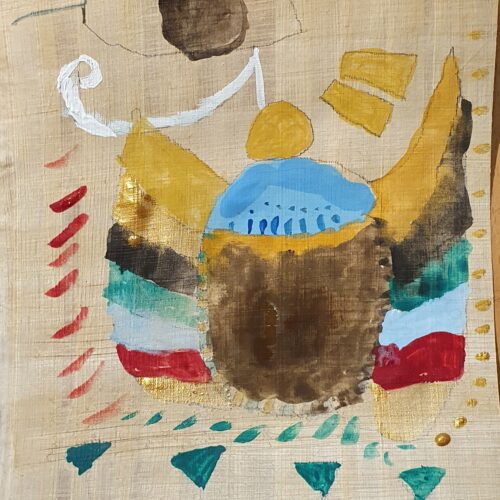 A student's papyrus painting of a scarab beetle.